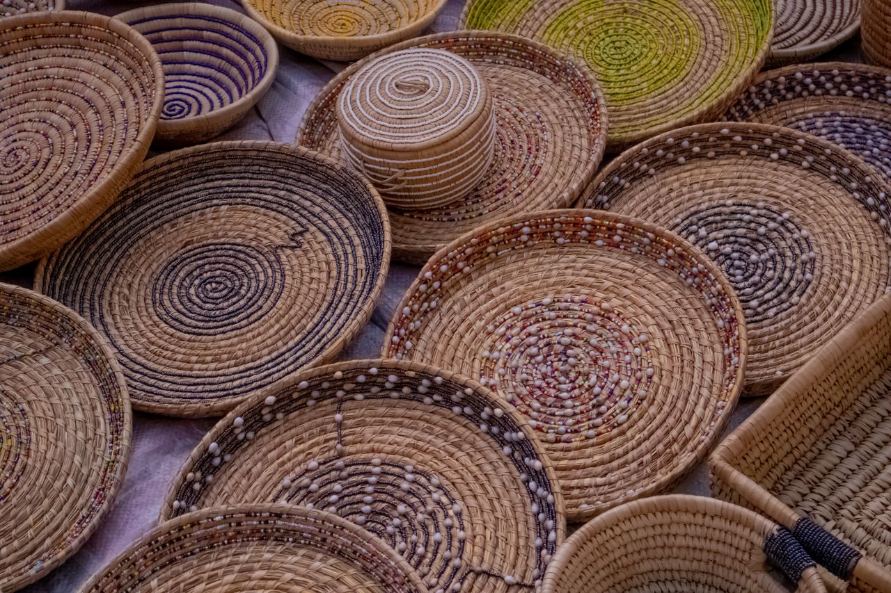 Variety of intricately woven baskets in natural tones, showcasing craftsmanship and texture.