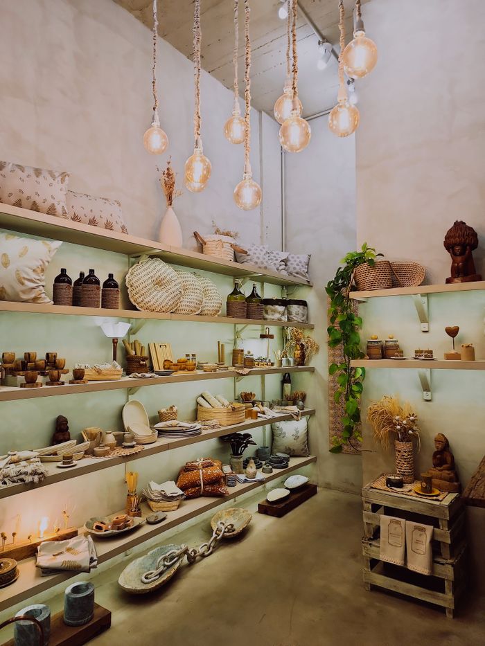 Charming shop interior showcasing decor items with ambient lighting, creating a cozy atmosphere.